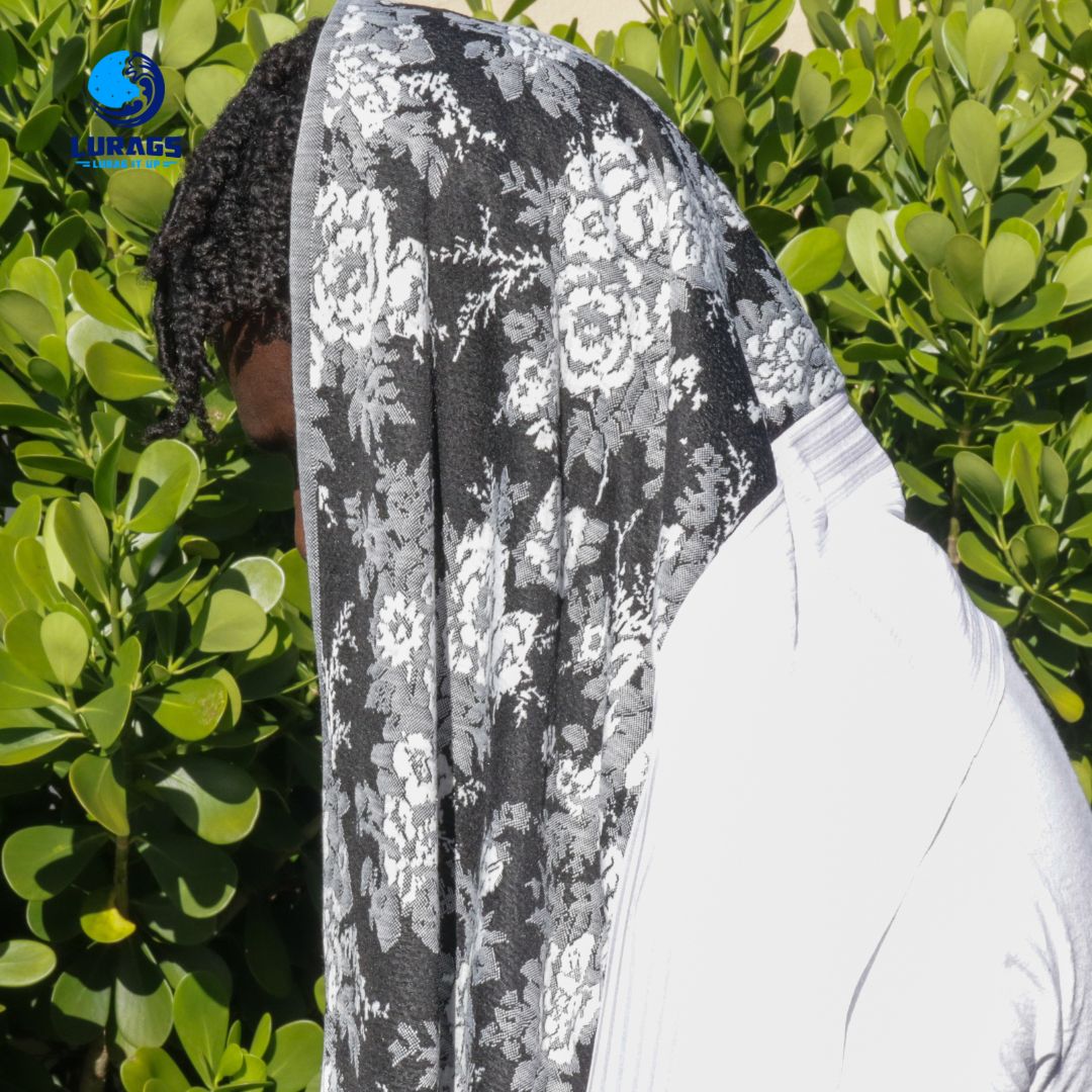 black man with male turbans with white flowers
